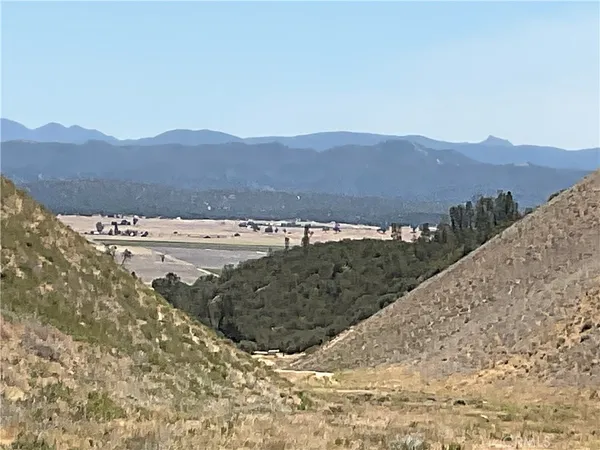 a view of a large mountain with mountains in the background