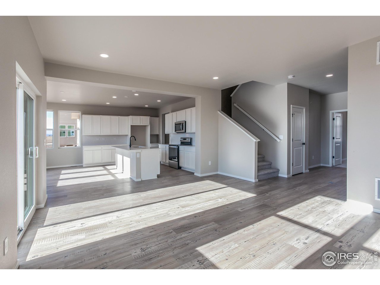 6634 4th St Road Greeley, CO 80634 - Photo 12 of 39 LIVING ROOM AND KITCHEN