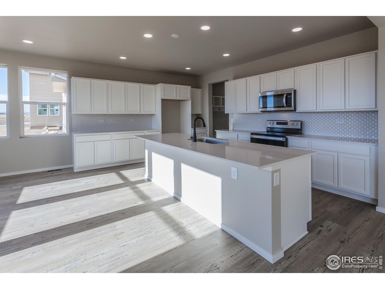 6634 4th St Road Greeley, CO 80634 - Photo 13 of 39 KITCHEN W/ ISLAND