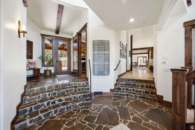 7885 North Rabbitbrush Court, Unit 13 Park City, UT 84098 - Photo 57 of 88 Entryway featuring natural stone flooring and stairs, vaulted ceiling with exposed wood beams, and a wood-framed glass double-door entrance