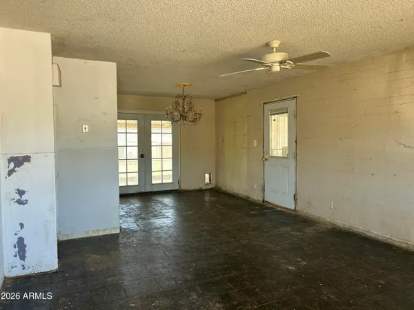 a view of a livingroom with a chandelier fan and a bathroom