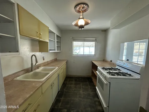 a kitchen that has a sink and lots of appliances