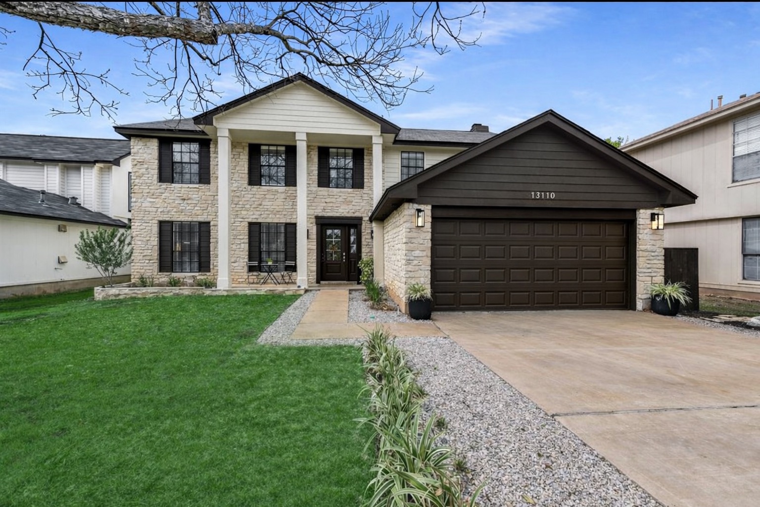 a front view of a house with a yard and garage