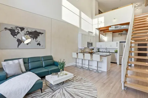 a kitchen with stainless steel appliances granite countertop a sink a stove top oven a counter space and cabinets