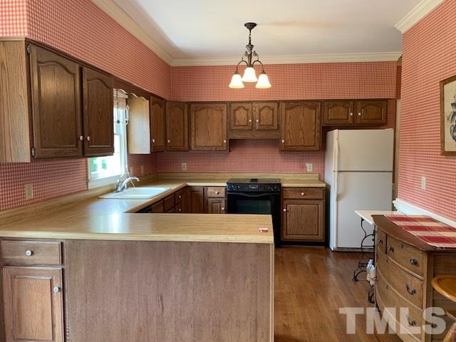 717 Brookfield Road Raleigh, NC 27615 - Photo 12 of 30 a kitchen with stainless steel appliances granite countertop a refrigerator a sink dishwasher a stove and a dining table with wooden floor