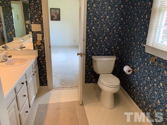 717 Brookfield Road Raleigh, NC 27615 - Photo 21 of 30 a bathroom with a toilet sink and mirror