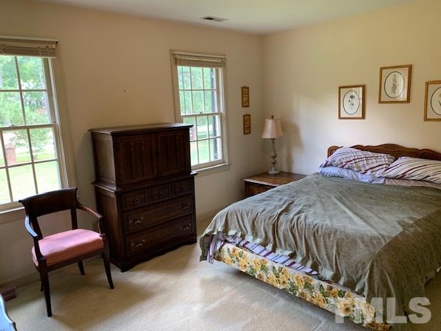717 Brookfield Road Raleigh, NC 27615 - Photo 23 of 30 a bedroom with a bed and a window