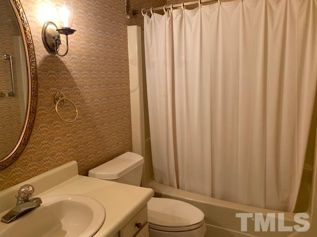 717 Brookfield Road Raleigh, NC 27615 - Photo 24 of 30 a bathroom with a sink a toilet and shower curtain