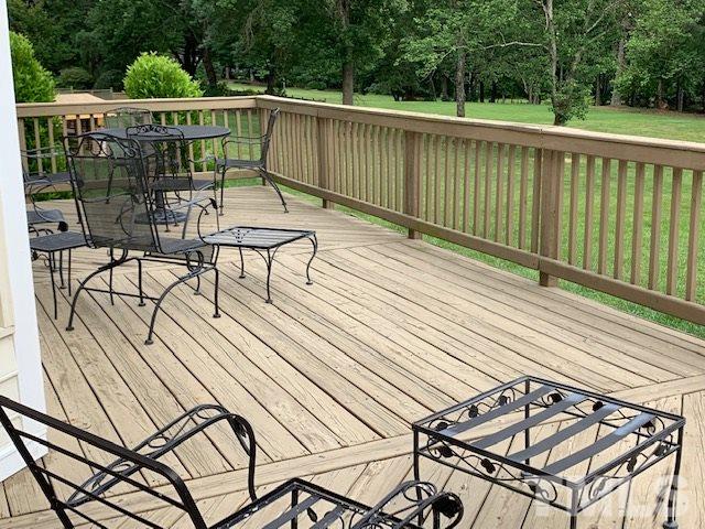 717 Brookfield Road Raleigh, NC 27615 - Photo 29 of 30 a view of a patio with table and chairs with wooden floor and fence