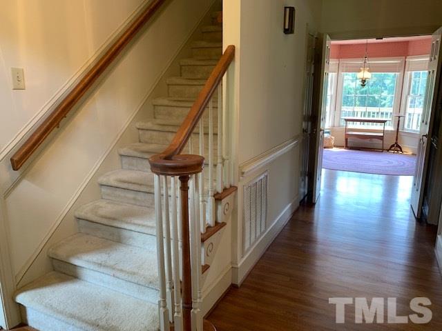 717 Brookfield Road Raleigh, NC 27615 - Photo 9 of 30 a view of entryway and hall with wooden floor