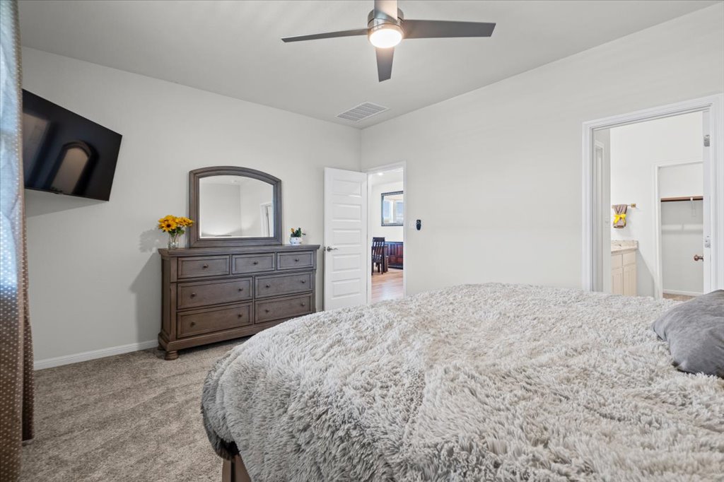 158 Gullivers Drive Elgin, TX 78621 - Photo 17 of 36 Even with a king sized bed, dual nightstands, and a large dresser, you still have plenty of breathing room.