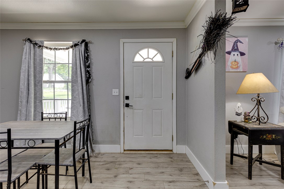 110 Avondale Road Anderson, SC 29624 - Photo 4 of 26 Enter into a naturally illuminated space featuring robust wood flooring and crown molding accents.