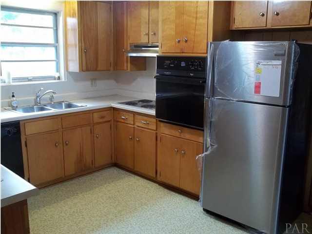 6916 Olsen Road Pensacola, FL 32506 - Photo 9 of 15 New stainless steel refrigerator still has wrapping on it.