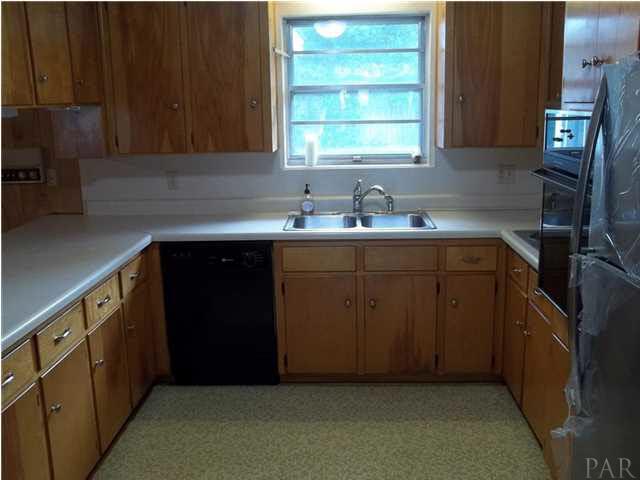 6916 Olsen Road Pensacola, FL 32506 - Photo 10 of 15 Lots of cabinets and a breakfast bar.