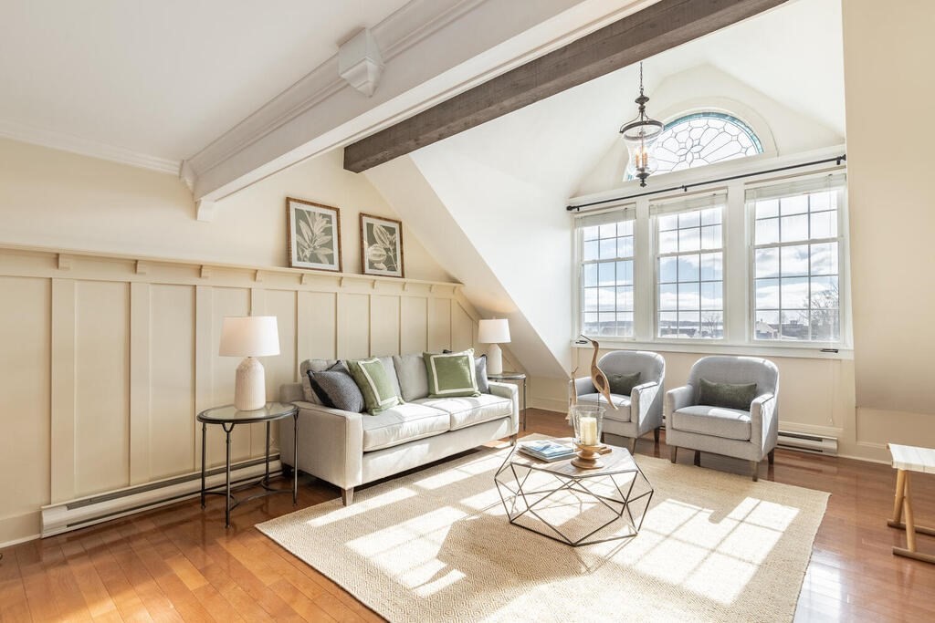 8 Summer Street, Unit 415 Gloucester, MA 01930 - Photo 19 of 32 a living room with furniture and a chandelier