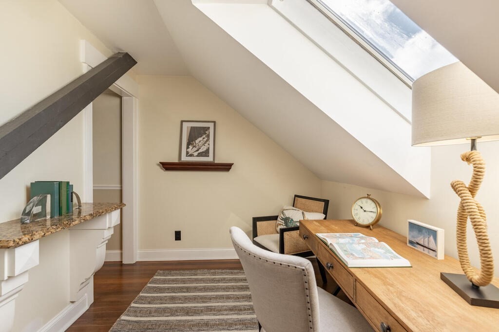 8 Summer Street, Unit 415 Gloucester, MA 01930 - Photo 23 of 32 a view of a bedroom with furniture and rug