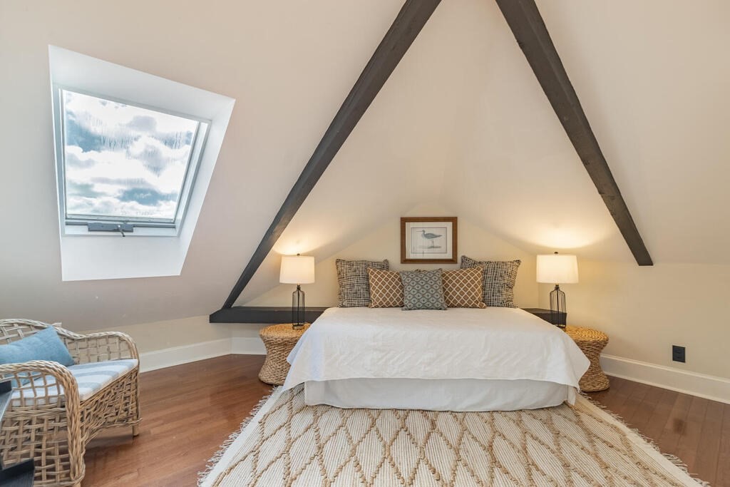 8 Summer Street, Unit 415 Gloucester, MA 01930 - Photo 25 of 32 a bedroom with a bed and wooden floor