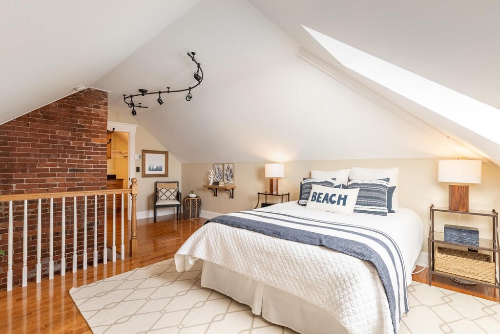 8 Summer Street, Unit 415 Gloucester, MA 01930 - Photo 30 of 32 a bedroom with a bed and a table