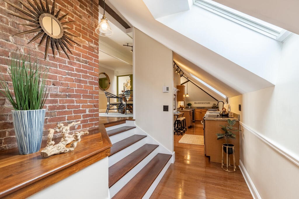 8 Summer Street, Unit 415 Gloucester, MA 01930 - Photo 6 of 32 a view of a hallway with wooden floor and staircase