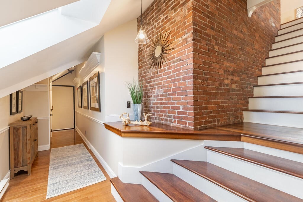 8 Summer Street, Unit 415 Gloucester, MA 01930 - Photo 7 of 32 a view of a living room area with furniture and wooden floor