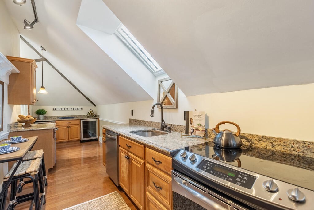 8 Summer Street, Unit 415 Gloucester, MA 01930 - Photo 9 of 32 a kitchen with sink stove and cabinets