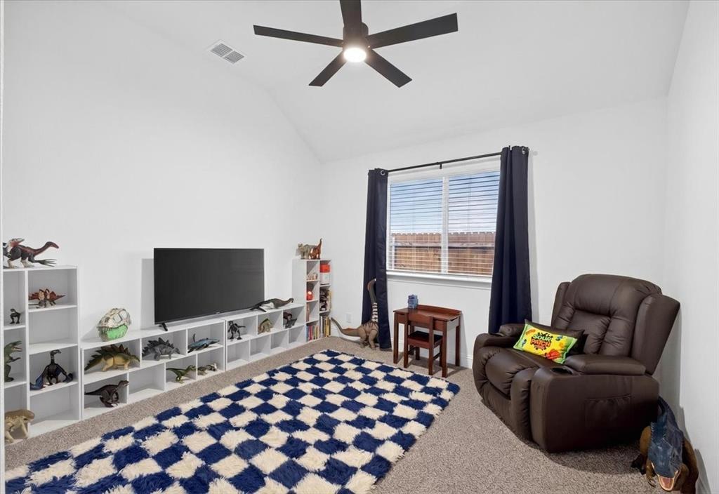 653 Godley Ranch Godley, TX 76044 - Photo 26 of 35 a living room with furniture and a flat screen tv