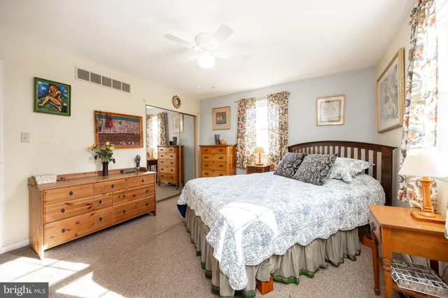 a bedroom with a bed and a dresser