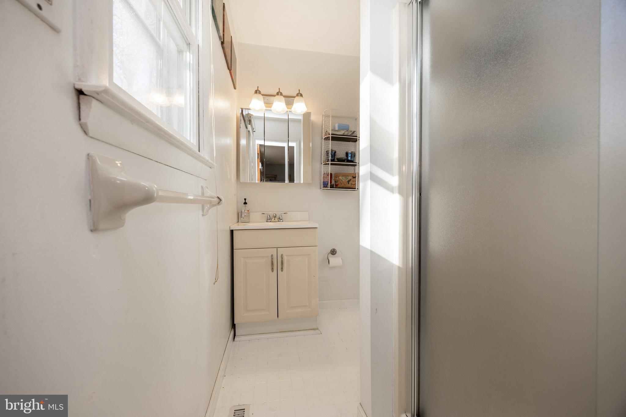 4455 Bethel Road Upper Chichester, PA 19061 - Photo 14 of 27 a bathroom with a sink and a mirror