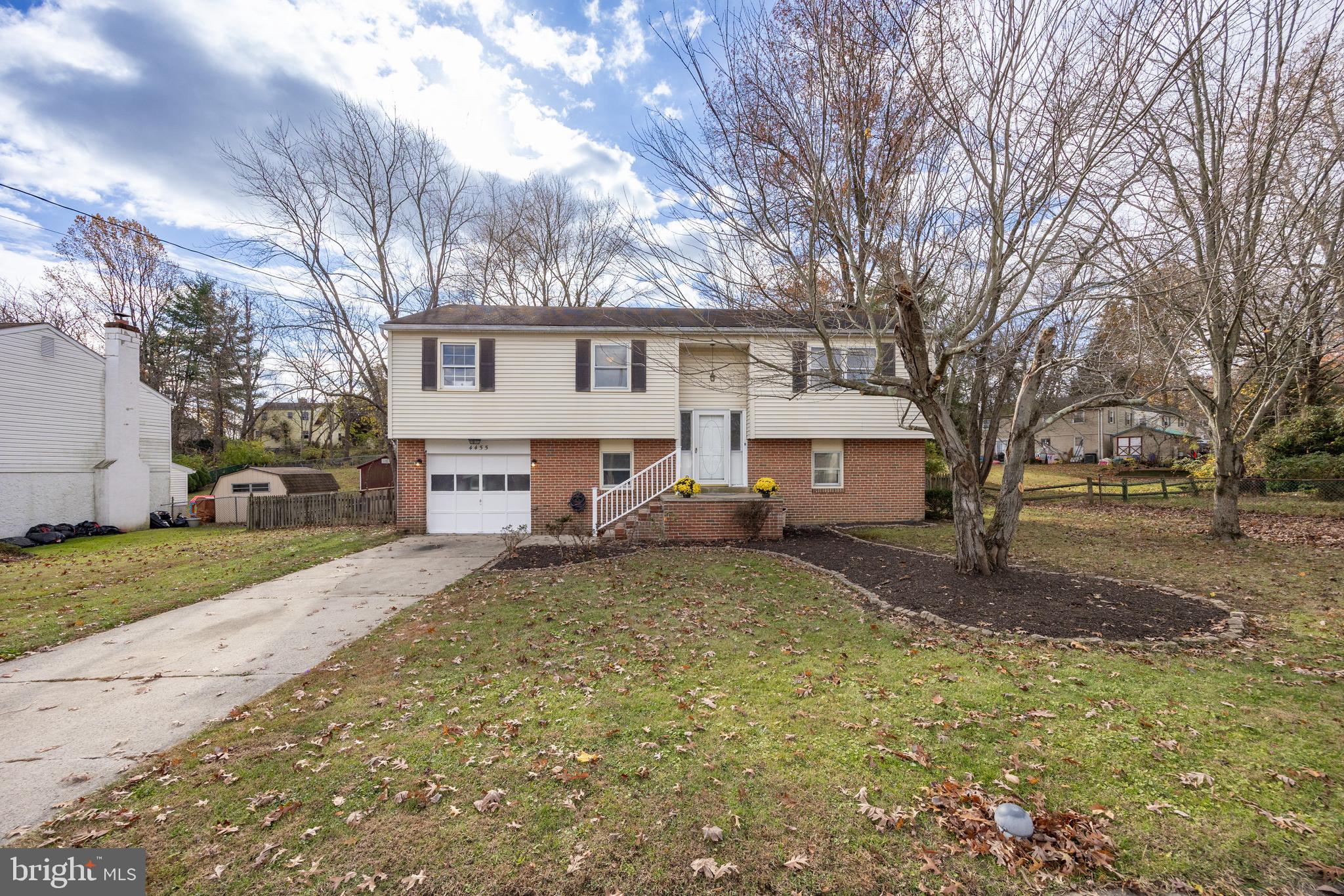 4455 Bethel Road Upper Chichester, PA 19061 - Photo 2 of 27 a white house that has a tree in front of it