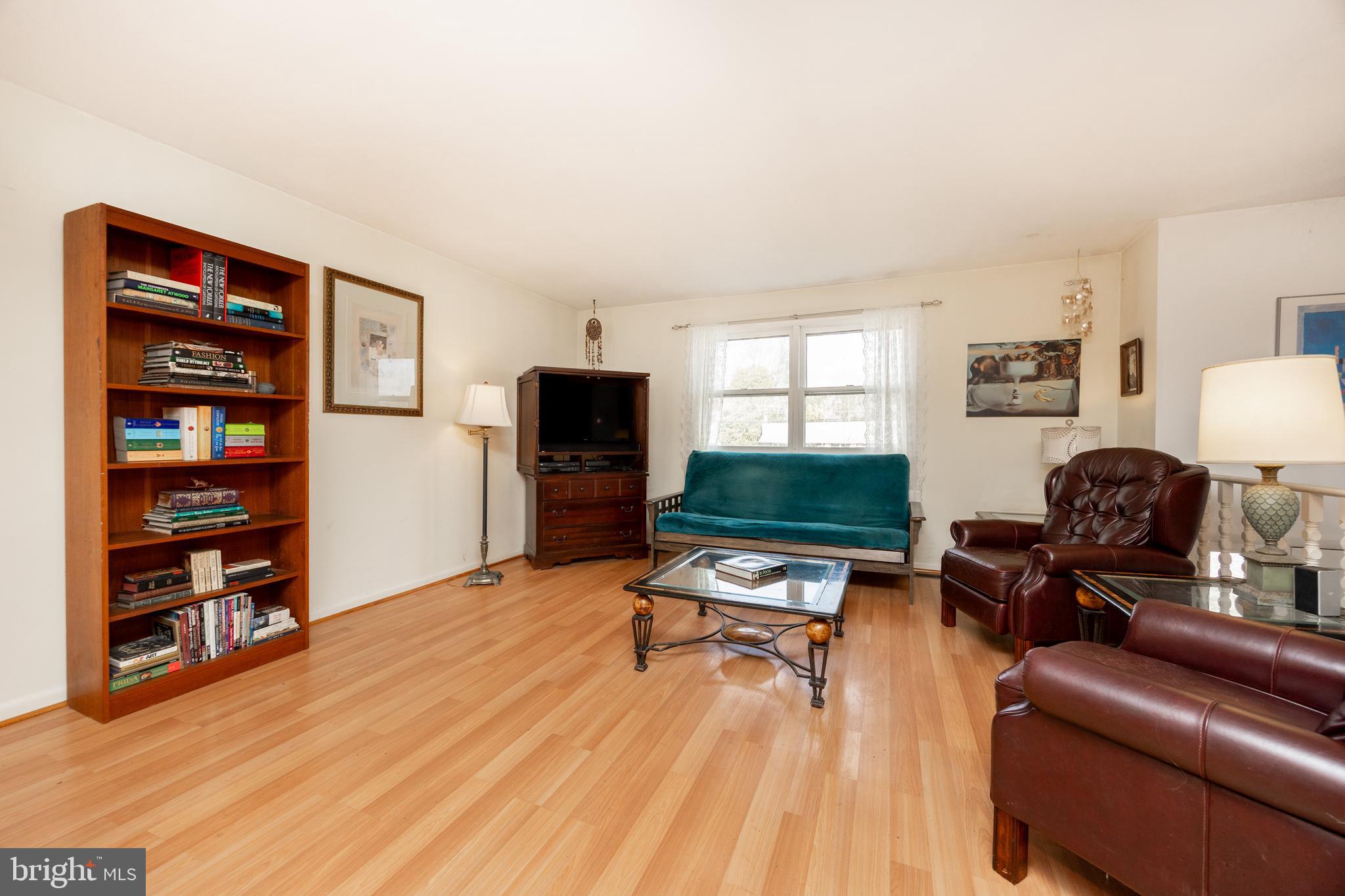4455 Bethel Road Upper Chichester, PA 19061 - Photo 6 of 27 a living room with furniture a rug and a flat screen tv
