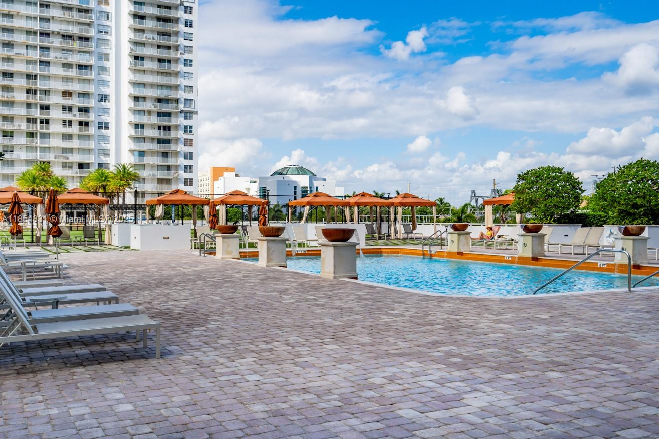 2801 Northeast 183rd Street, Unit 1401W Aventura, FL 33160 - Photo 13 of 26 a view of pool with outdoor seating
