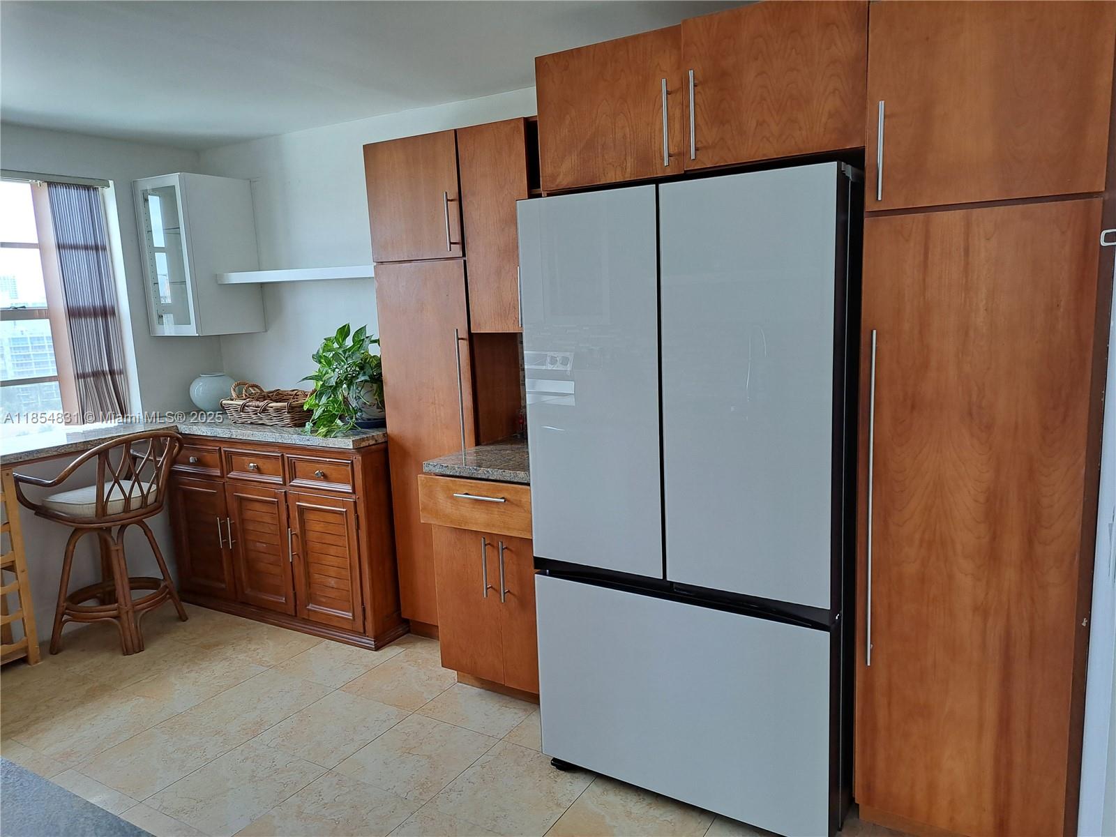 2801 Northeast 183rd Street, Unit 1401W Aventura, FL 33160 - Photo 19 of 26 a kitchen with stainless steel appliances a refrigerator a sink a stove and white cabinets