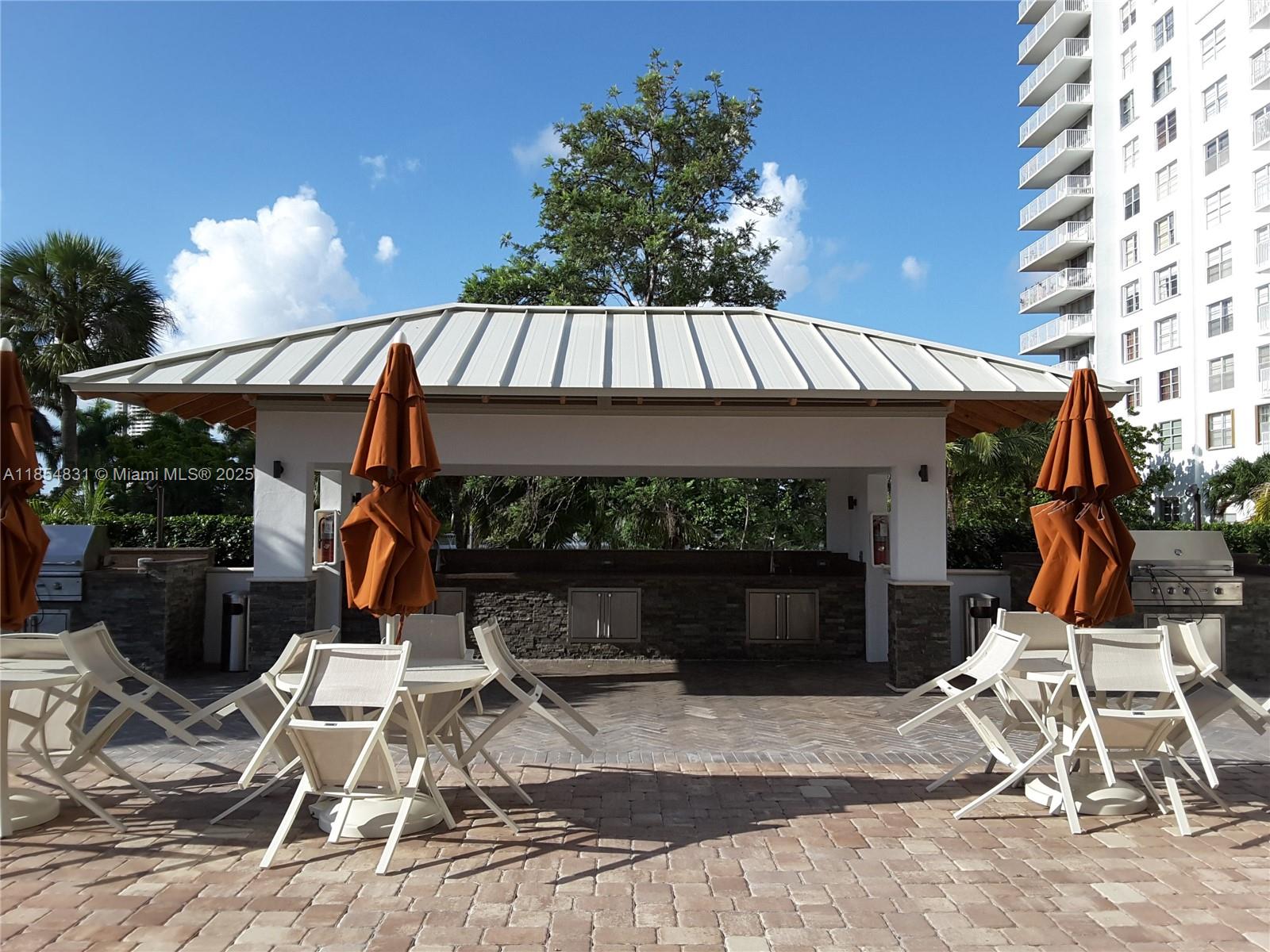 2801 Northeast 183rd Street, Unit 1401W Aventura, FL 33160 - Photo 24 of 26 a view of a chairs and table in the patio