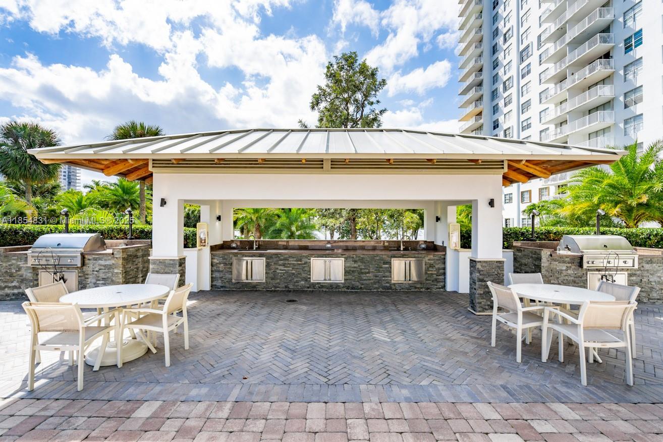 2801 Northeast 183rd Street, Unit 1401W Aventura, FL 33160 - Photo 25 of 26 a patio with a table and chairs