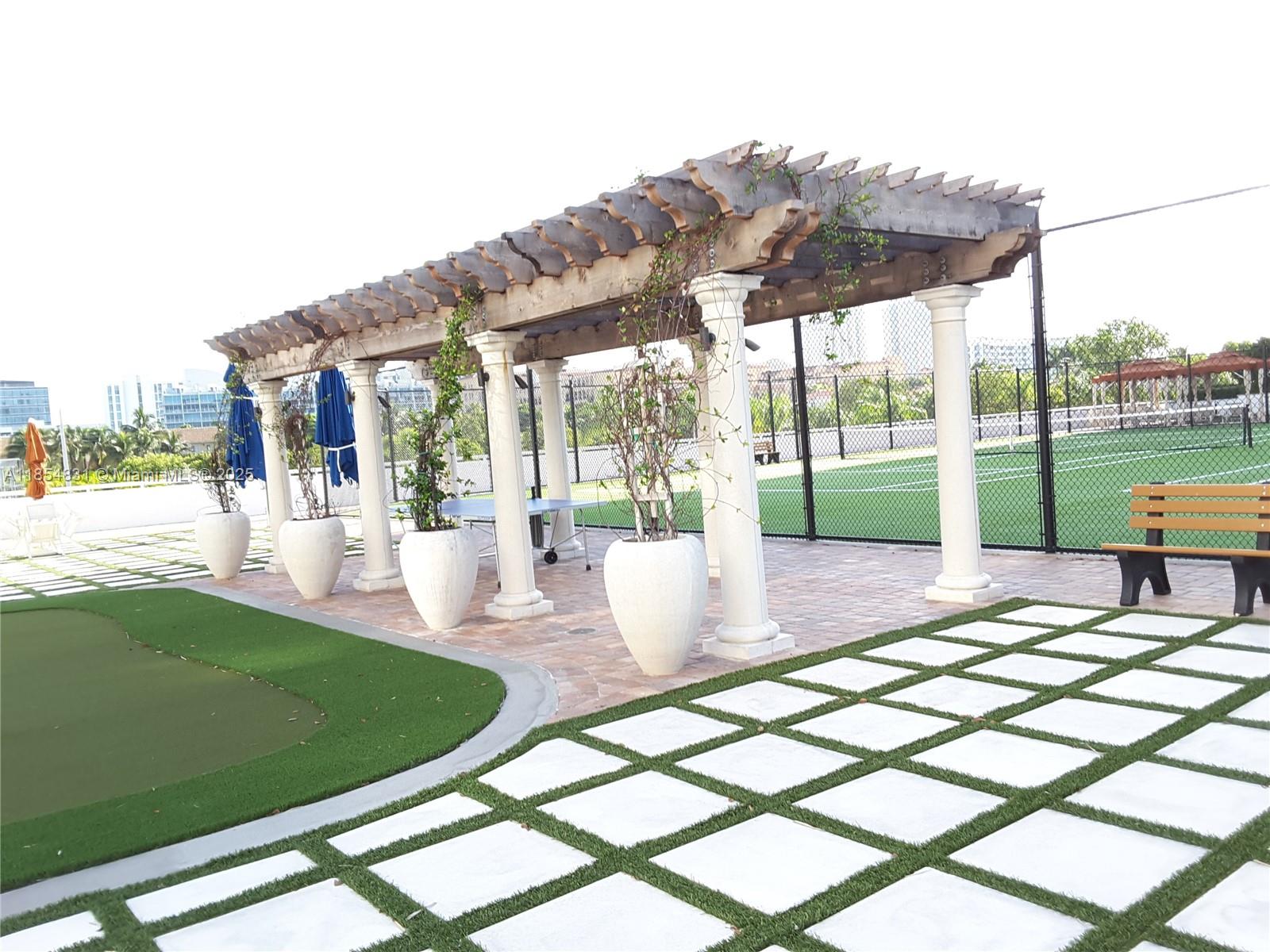 2801 Northeast 183rd Street, Unit 1401W Aventura, FL 33160 - Photo 3 of 26 a view of outdoor space yard deck patio and outdoor kitchen