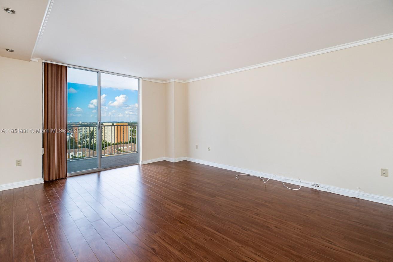 2801 Northeast 183rd Street, Unit 1401W Aventura, FL 33160 - Photo 9 of 26 wooden floor in an empty room with a window