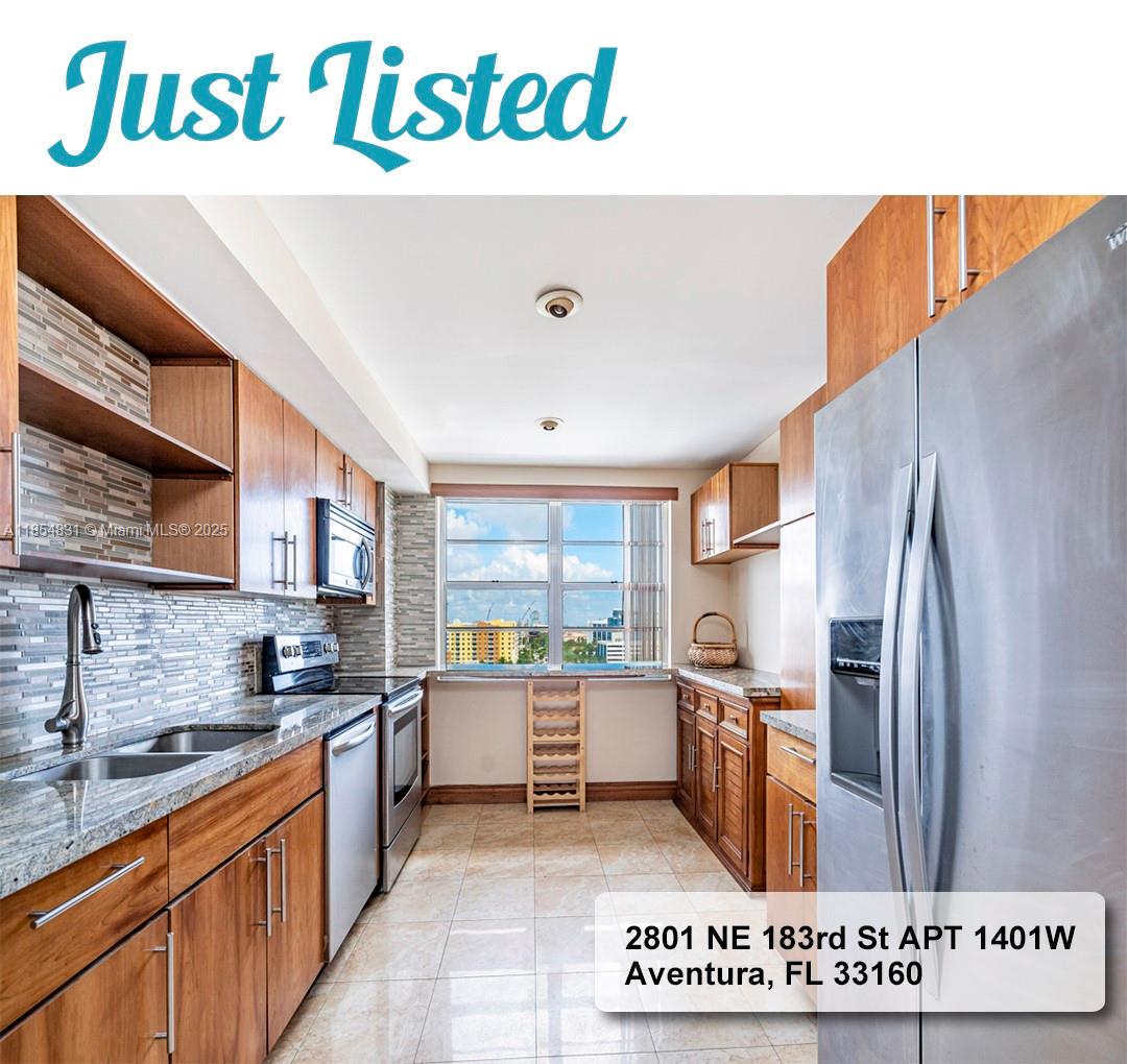 2801 Northeast 183rd Street, Unit 1401W Aventura, FL 33160 - Photo 10 of 26 a kitchen with stainless steel appliances a sink a stove a refrigerator and a microwave