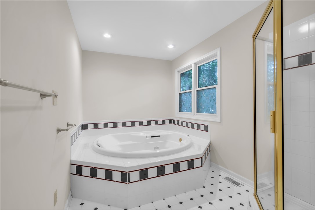149 Inlet Pointe Drive Anderson, SC 29625 - Photo 17 of 43 Indulge in a relaxing soak in this primary bath featuring a corner tub and glass-enclosed shower.