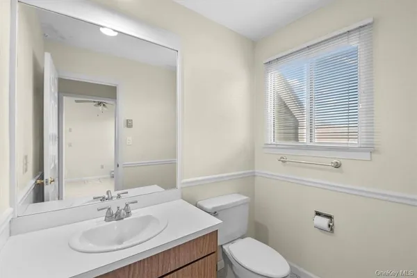 a bathroom with a sink a toilet and a mirror