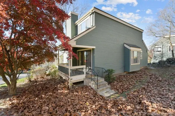 a view of a house with a yard and wooden fence