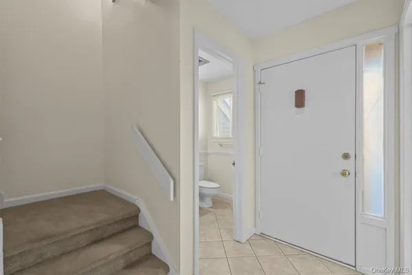 a view of a hallway with toilet and shower