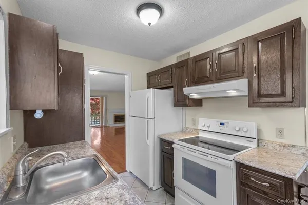 a kitchen with stainless steel appliances granite countertop a refrigerator stove and sink