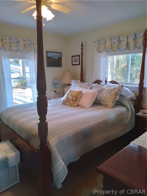 175 Seaside Way Gwynn, VA 23076 - Photo 17 of 48 a bedroom with a bed and glass windows