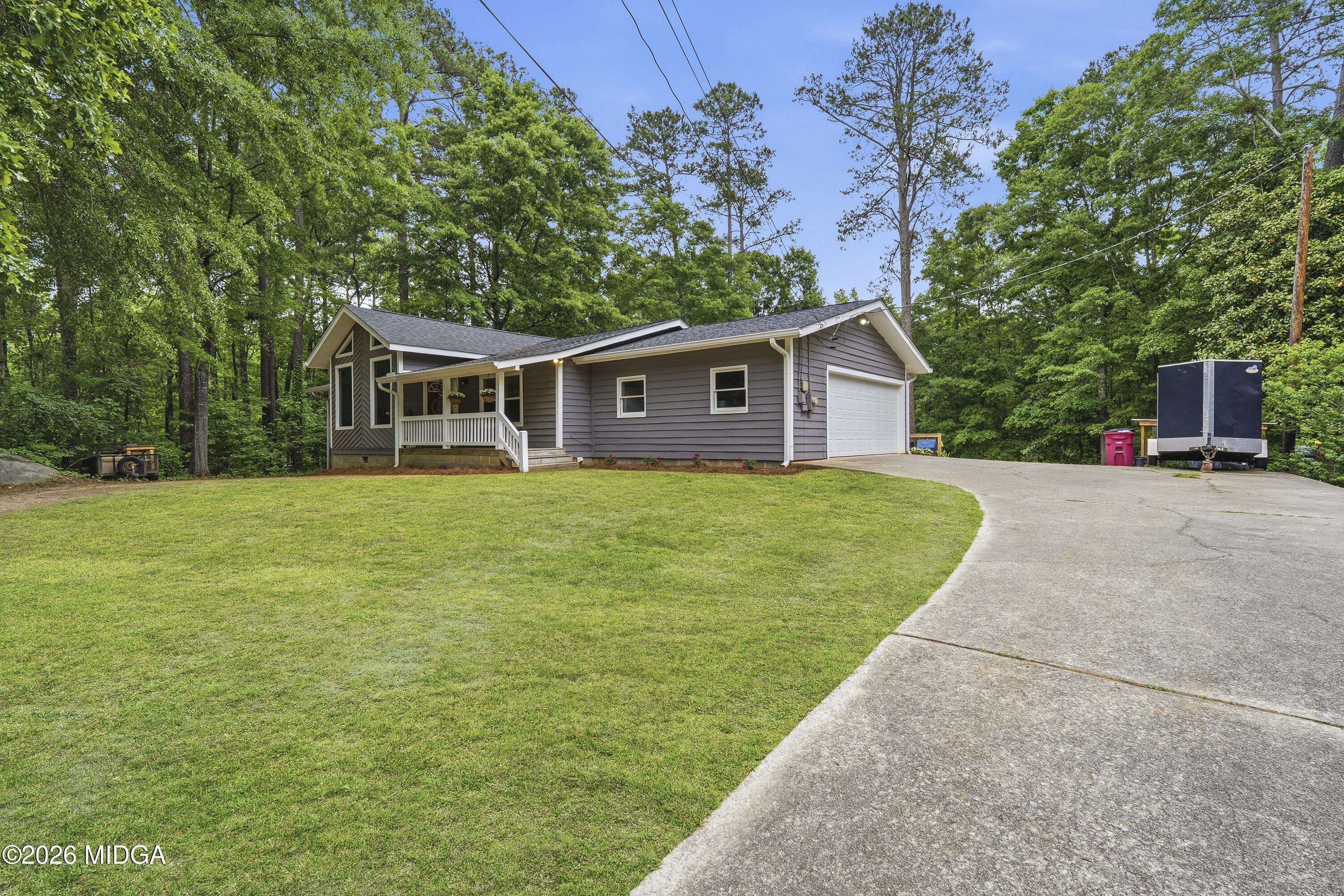a view of a house with a yard and sitting area