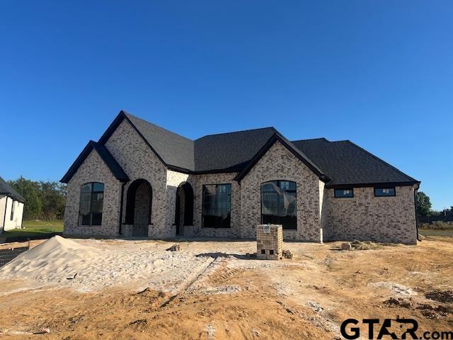 a view of a house with a yard covered in snow