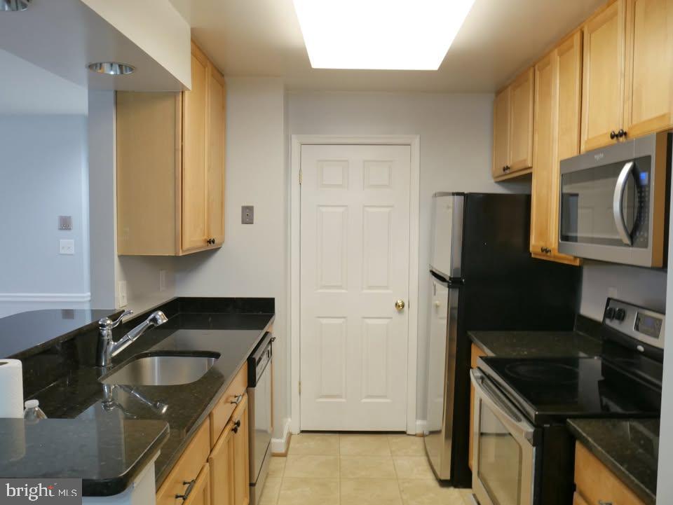 13701 Modrad Way, Unit 9C12 Silver Spring, MD 20904 - Photo 7 of 12 a kitchen with stainless steel appliances granite countertop a sink stove and refrigerator