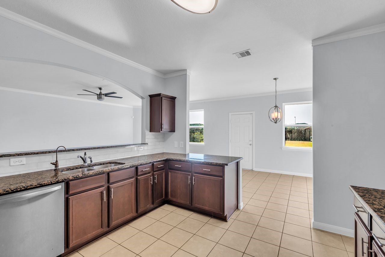 22703 Threefold Ridge Drive Hockley, TX 77447 - Photo 21 of 36 a kitchen with stainless steel appliances granite countertop a sink and cabinets