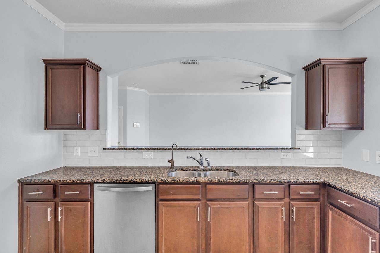 22703 Threefold Ridge Drive Hockley, TX 77447 - Photo 22 of 36 a sink with granite countertop cabinets