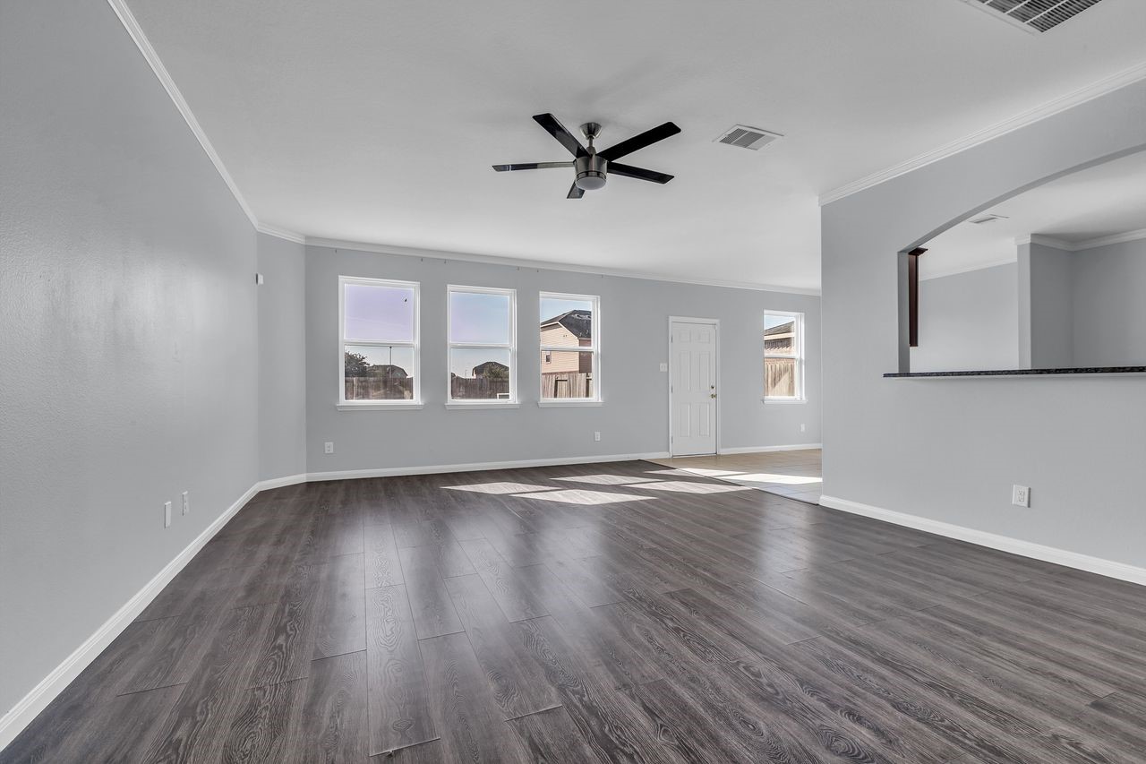 22703 Threefold Ridge Drive Hockley, TX 77447 - Photo 7 of 36 a view of an empty room with wooden floor and a window