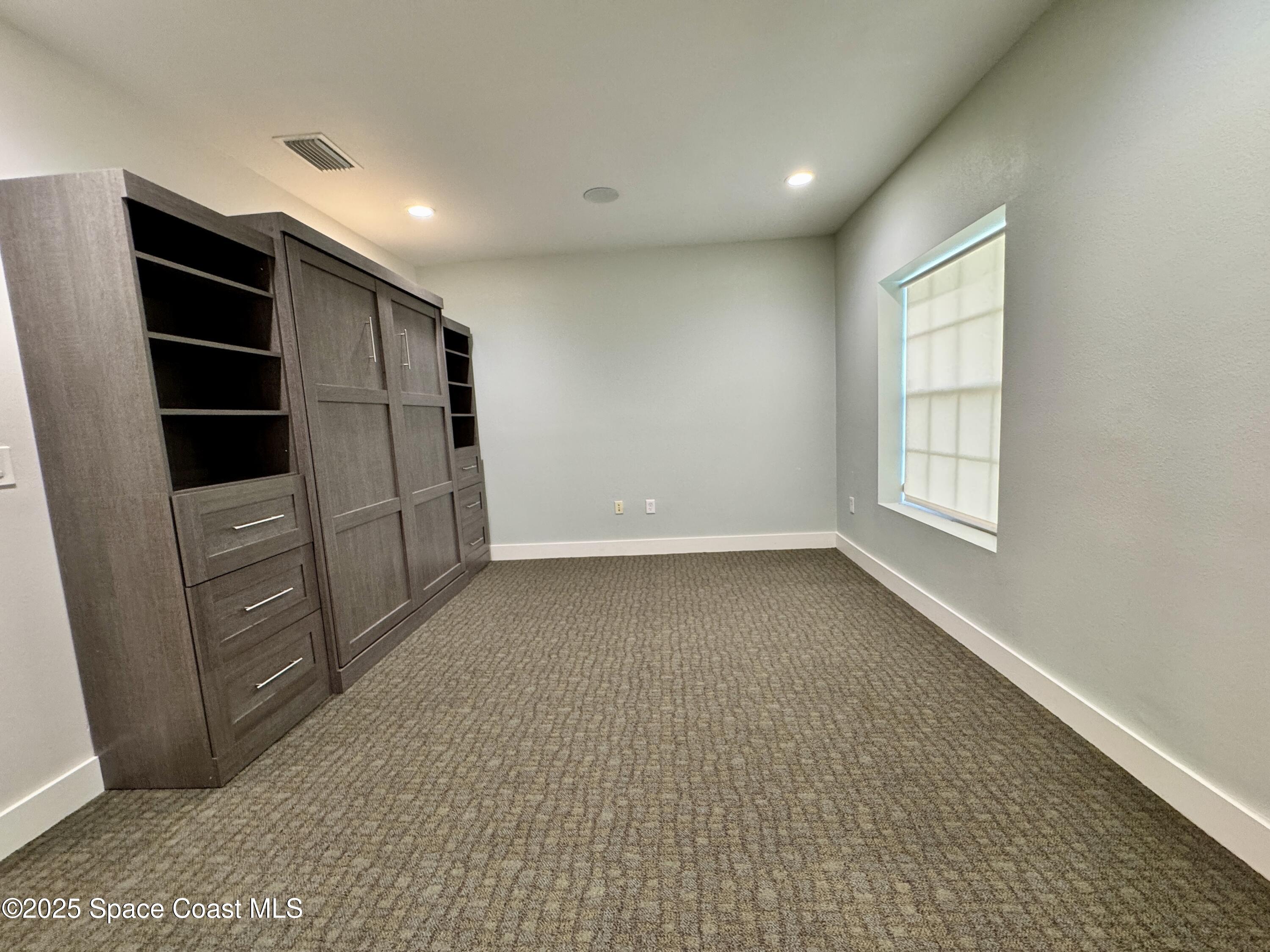 3210 North Wickham Road, Unit 2 Melbourne, FL 32935 - Photo 12 of 14 a view of an empty room with closet